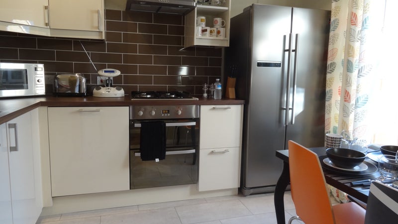 Photo 1: Fully equipped modern kitchen opens onto the garden
