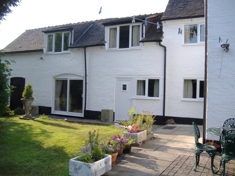 Photo 1: Rear of house - patio doors to sitting room