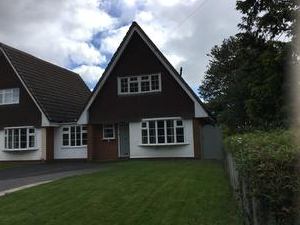 Photo 1: Outside of the house with a large driveway for parking.
