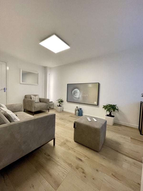 Photo 1: Living room with 65inch smart t.v