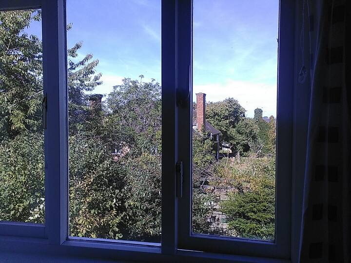 Photo 1: view from bedroom looks onto rear garden with village beyond