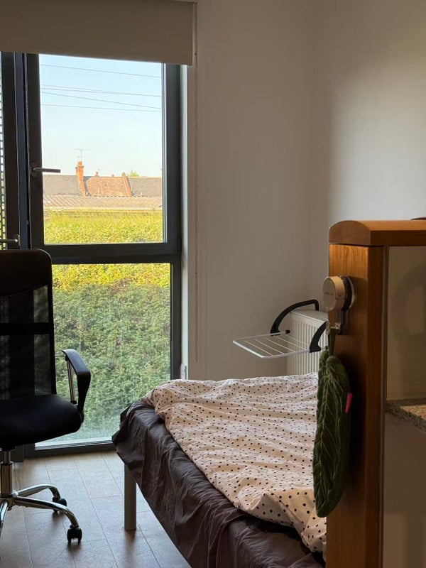 Photo 1: Floor-to-ceiling window facing the bed and desk area