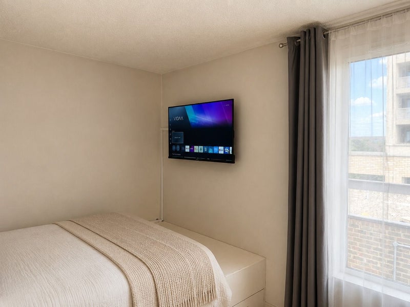 Photo 1: Wall-mounted TV Bedroom 2