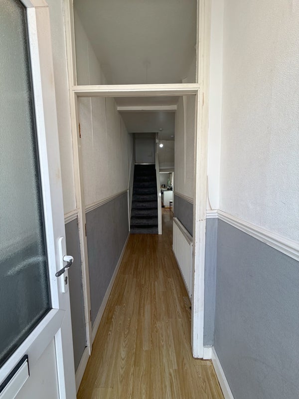 Photo 1: Front entrance through to kitchen