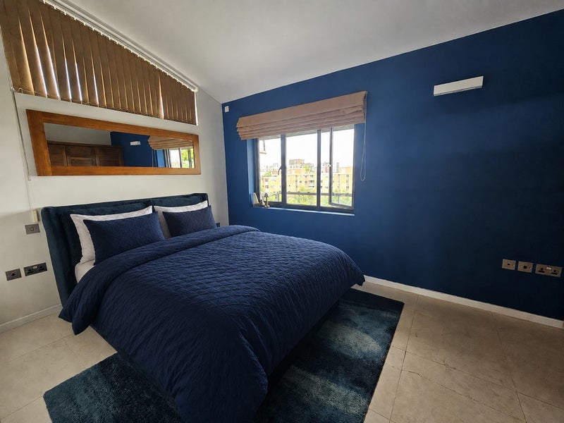 Photo 1: King sized ottoman bed. Plenty of storage space in the room.