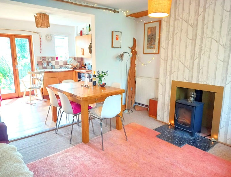 Photo 1: open plan kitchen / dining area with woodburner