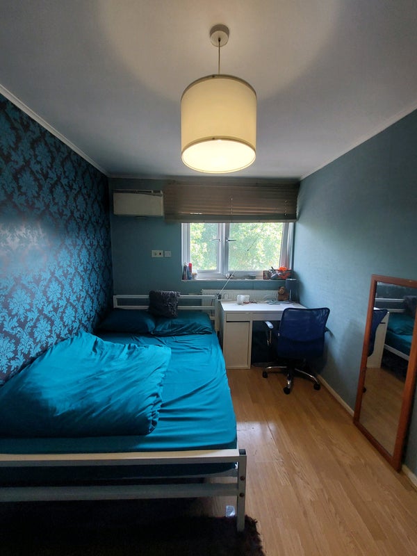 Photo 1: Double bed with work table, chair and table lamp.