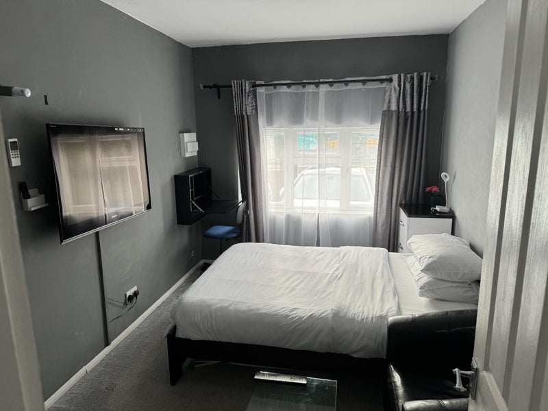 Photo 1: Bedroom, having a double bed, TV and work desk k