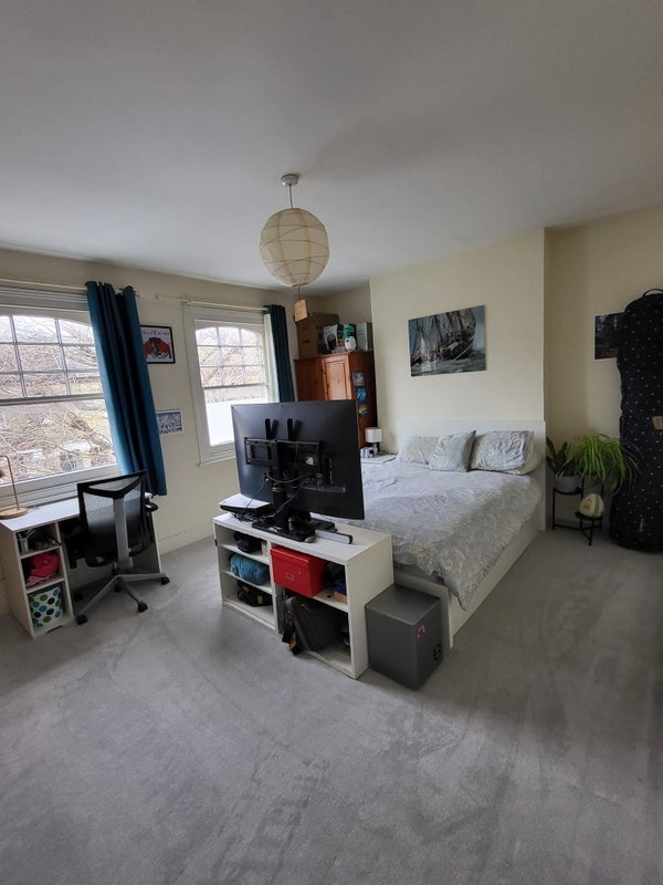 Photo 1: The bedroom! It's currently laid out differently but it is big with two large windows