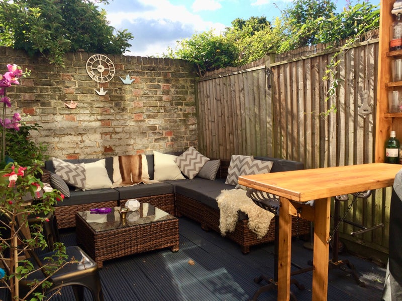 Photo 1: A perfectly private walled garden with only a playing field beyond makes outdoor living easy here