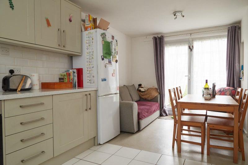 Photo 1: Kitchen and shared living space
