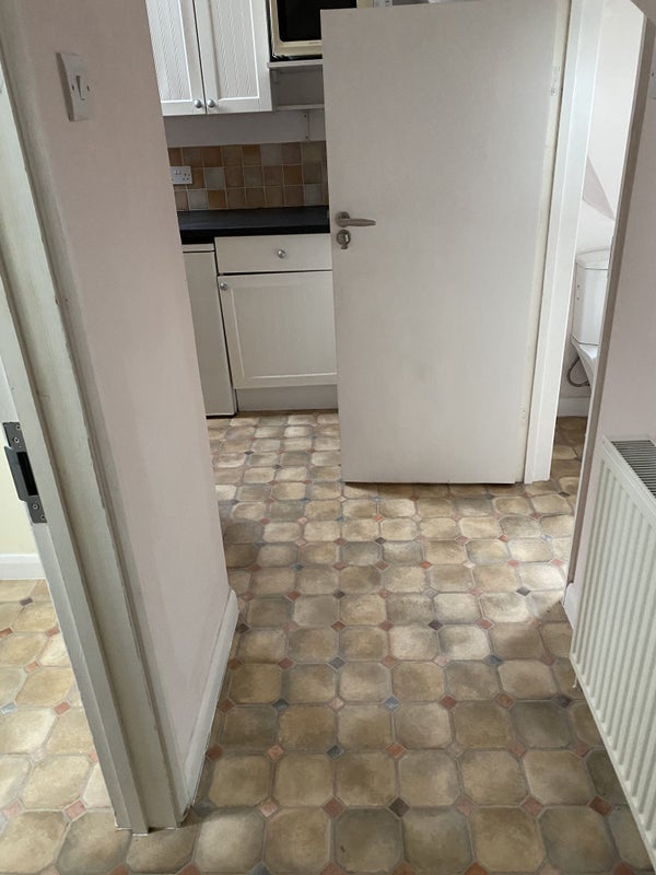Photo 1: Entrance is on the left, bathroom on right and small kitchen area ahead