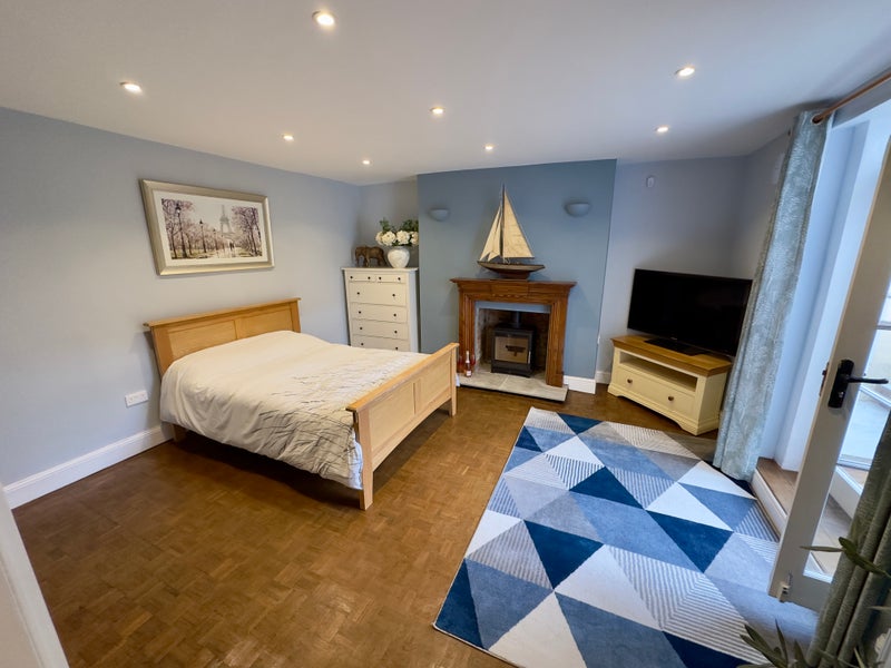 Photo 1: Elegant Living & Sleeping Space with Feature Log Burner