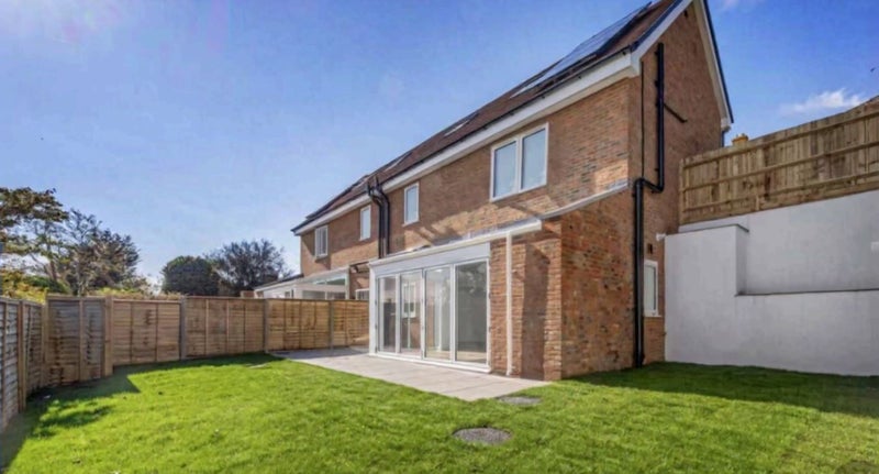 Photo 1: Outside view of house and back garden
