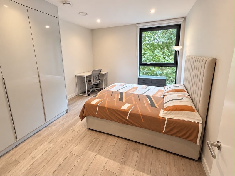 Photo 1: The bedroom, gets plenty of natural light