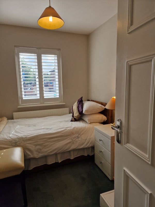 Photo 1: Your room — bright, restful and ready, with shutters and a fold-away study desk.