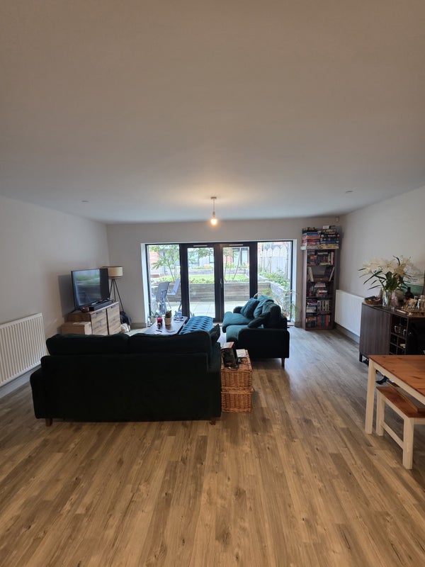 Photo 1: Living area with patio