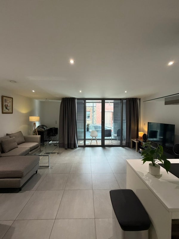 Photo 1: shared living room + balcony, table hidden