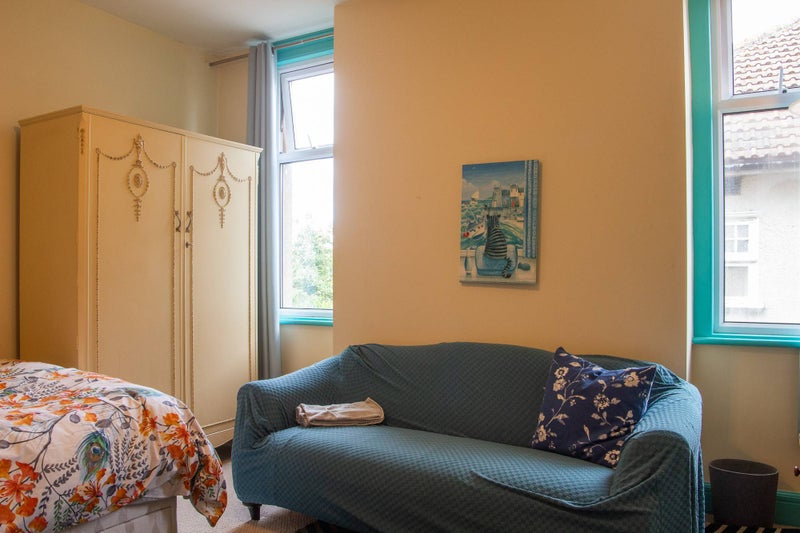 Photo 1: Sofa. Large Wardrobe. Two windows.