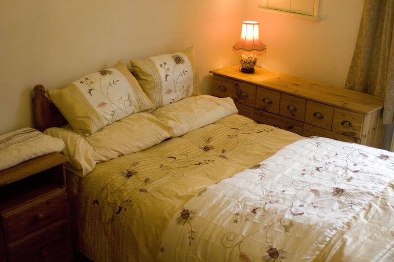 Photo 1: View of the room showing bed (small double) and chest of drawers