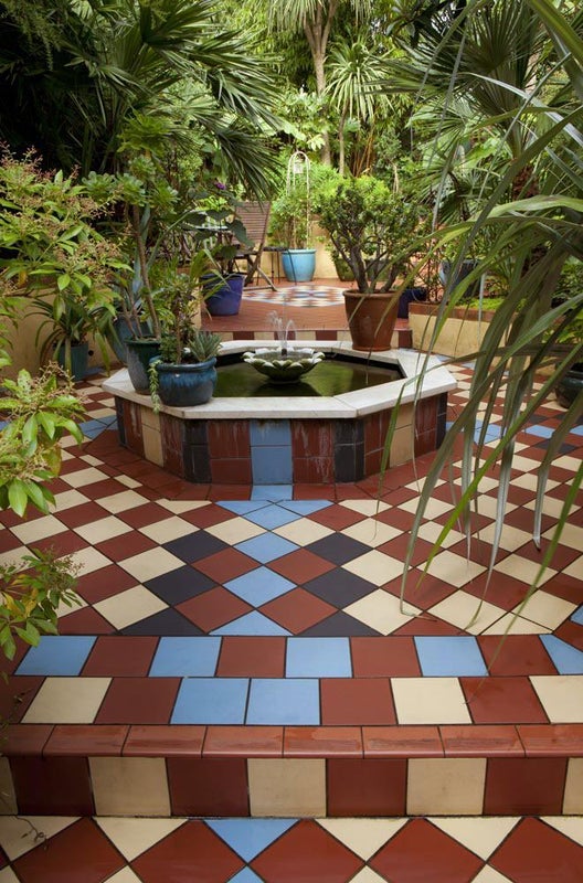 Photo 1: Tiled rear garden with fountain.