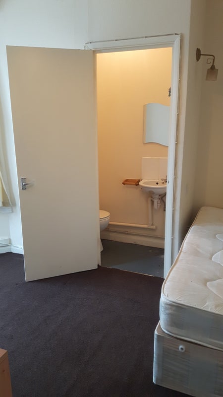 Photo 1: bed with ensuite toliet/wash basin door open
