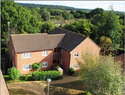 Photo 1: Front of apartment building