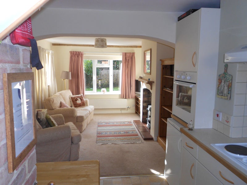 Photo 1: Open plan living area. View from the kitchen