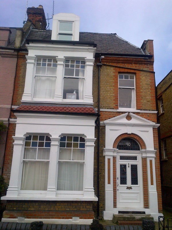 Photo 1: front of house with attic above