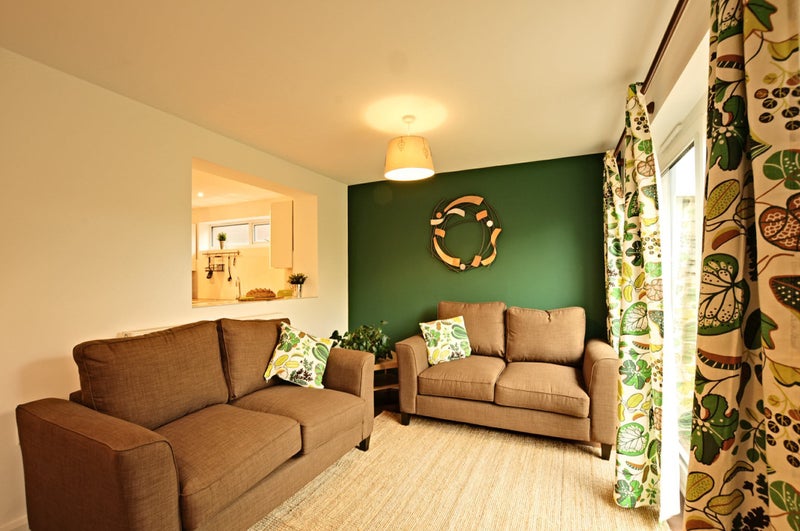 Photo 1: Shared lounge witth french windows out to patio and garden