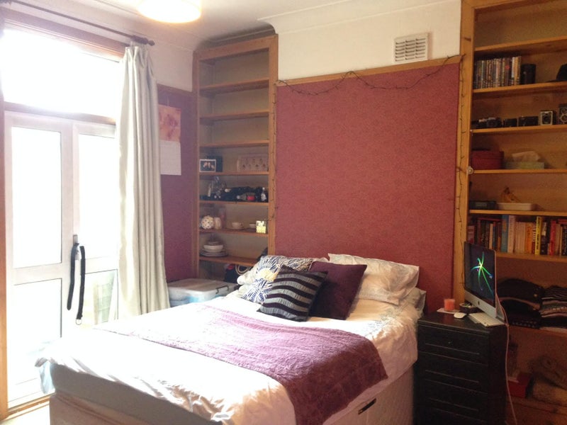 Photo 1: BEDROOM... high ceilingm with doors open onto garden (the room is now painted white..)