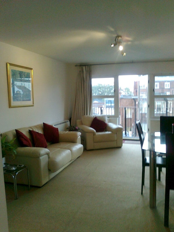 Photo 1: Spacious, bright living room with balcony.