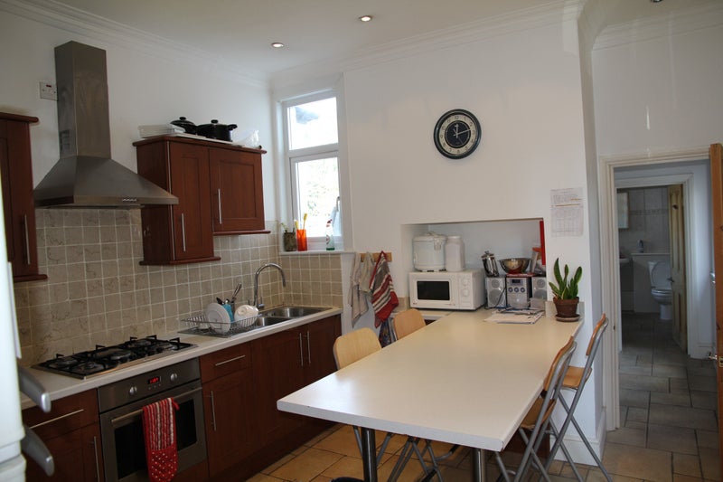 Photo 1: kitchen with 3 fridges, laundry room through door