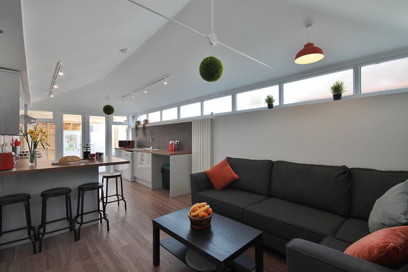 Photo 1: Comfortable living area with large TV