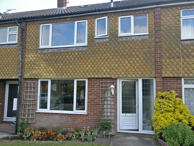 Photo 1: Two story house with front and back garden