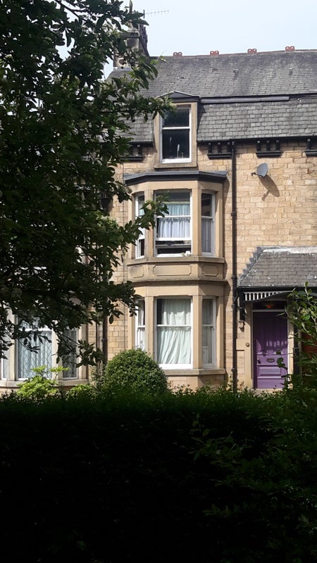 Photo 1: front of house from park