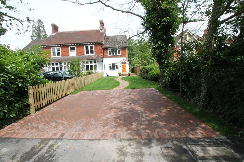 Photo 1: Front of house with parking