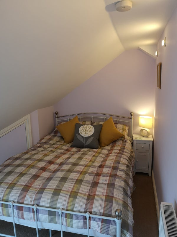 Photo 1: Double bed in front of house loft conversion.