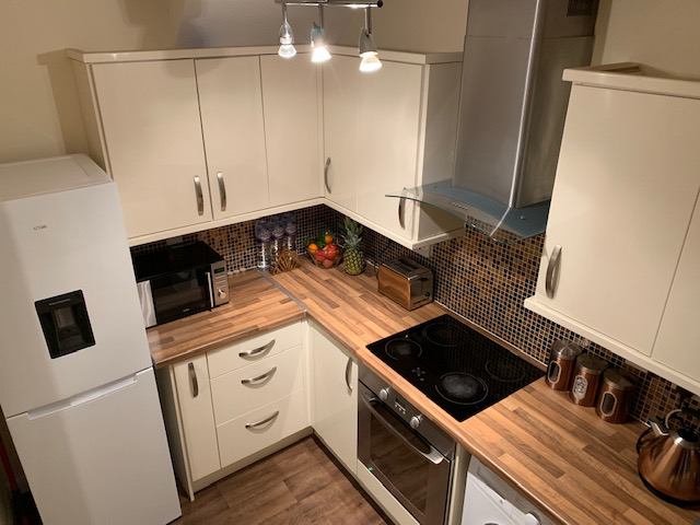 Photo 1: Stylish Luxury Kitchen, fully equipped with cooking utensils, plates and cutlery