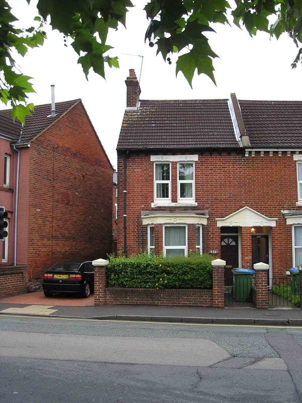 Photo 1: Front of house with driveway