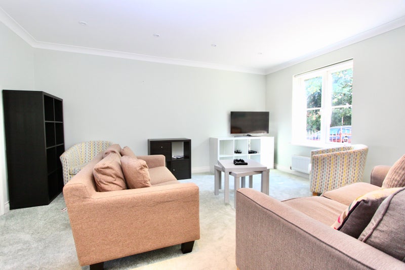 Photo 1: Shared living room with TV (Ground floor)