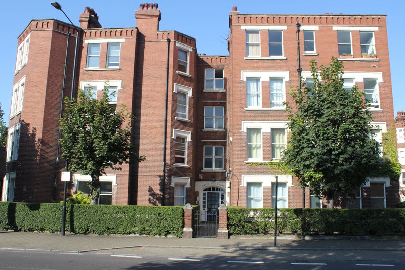 Photo 1: Front entrance of mansion block