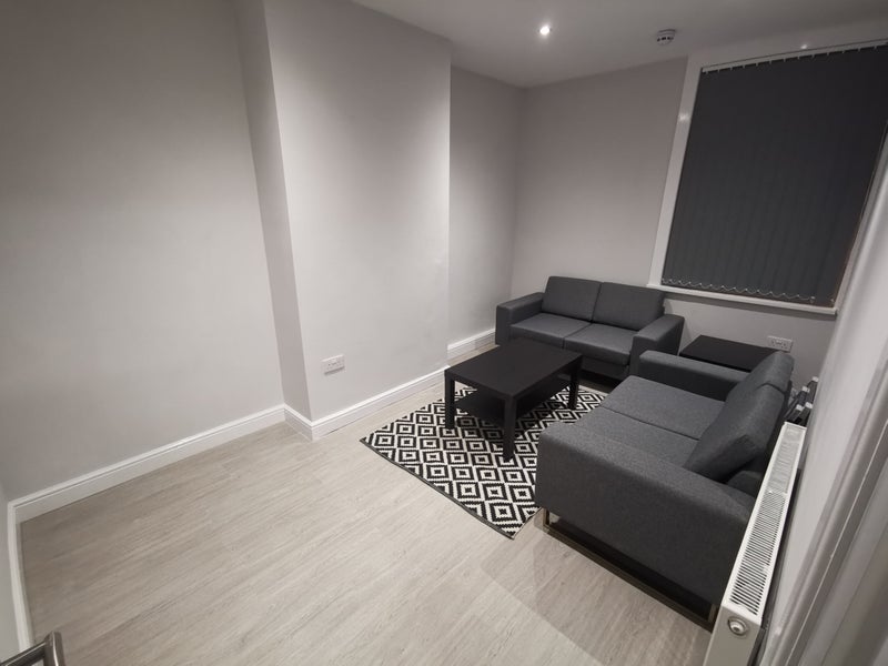 Photo 1: communa living area with wall mounted Smart TV