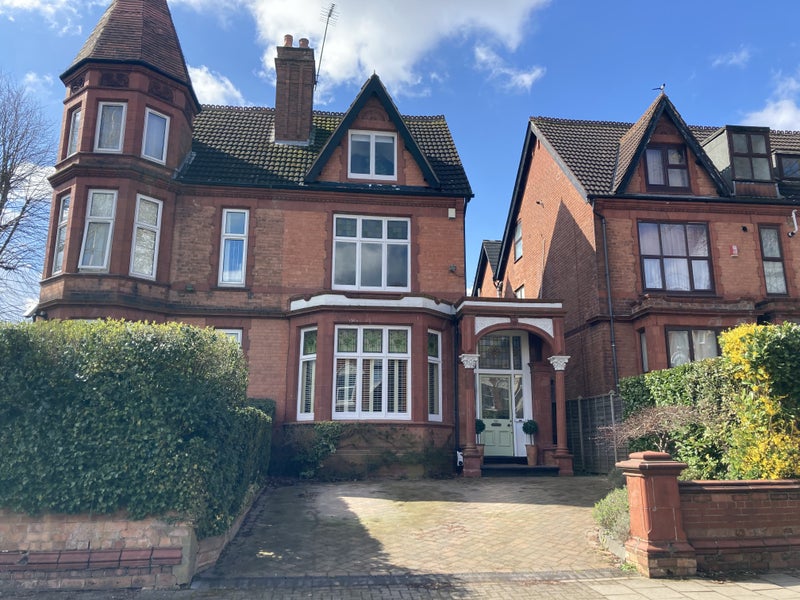 Photo 1: Front of house - third floor visible