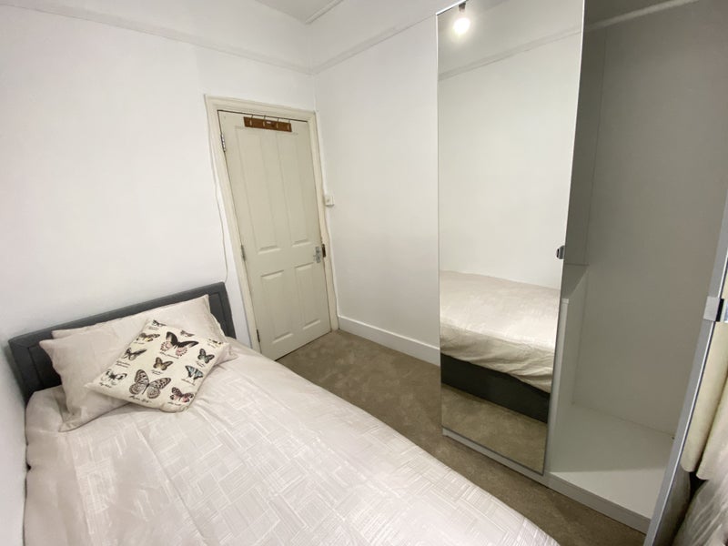 Photo 1: The room comes furnished with single bed and mirrored wardrobe. 