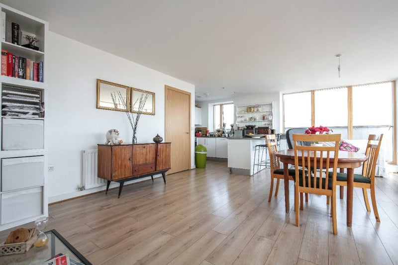 Photo 1: Dining area + kitchen (the cabinet is no longer there). The kitchen is very decently sized; it’s j