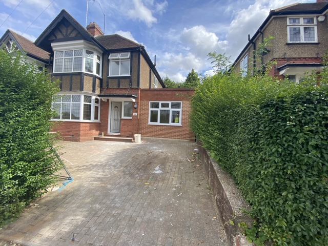 Photo 1: Front of house with parking