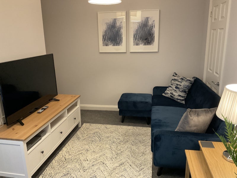 Photo 1: Living room with 50 inch 4K smart TV