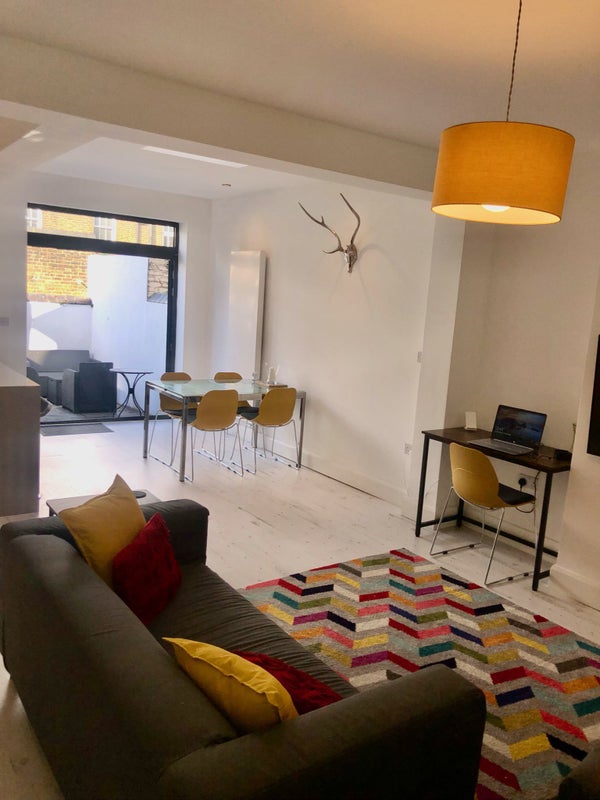 Photo 1: Large communal area with 2 double sofas, brand new 50" HD TV, workstation, full size kitchen with at