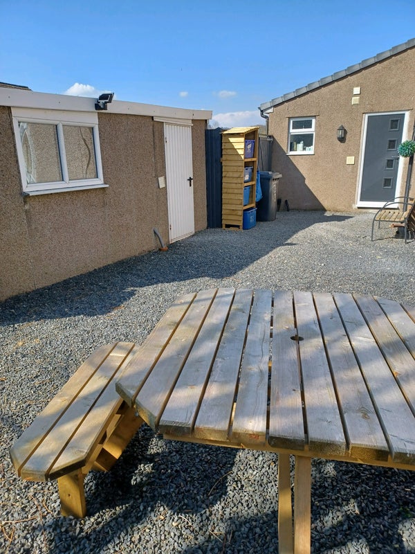 Photo 1: Picnic table/drying area and garage storage